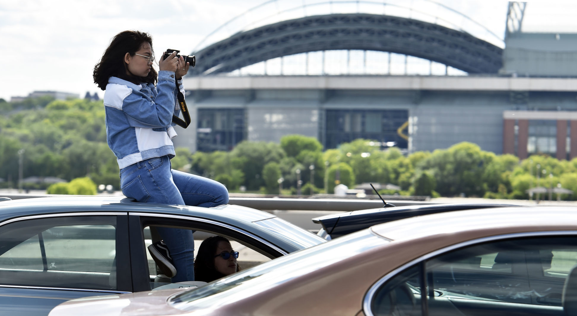 Photographer with Miller Park behind